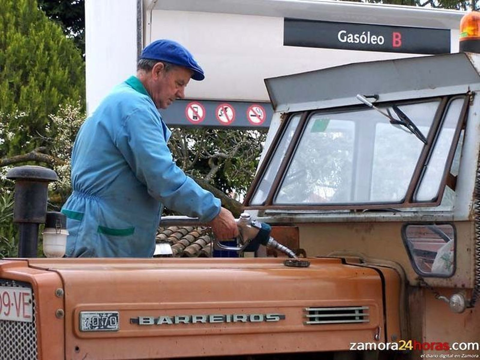 Un hombre llena el depósito de su tractor