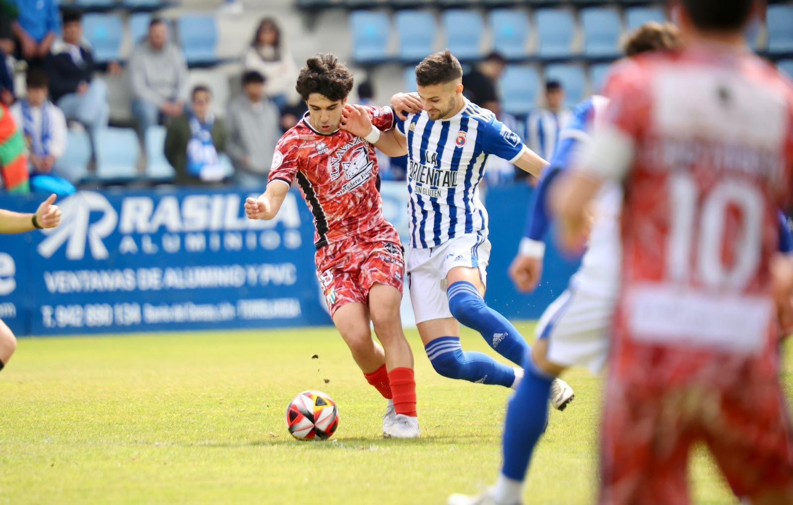 Alonso García pelea por un balón ante la Gimnástica de Torrelavega FOTO CD GUIJUELO