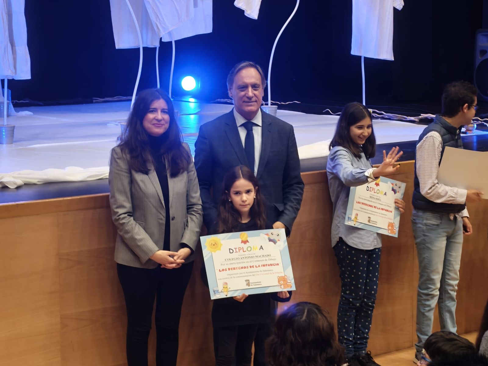 Los niños del concurso de dibujo de reciben sus diplomas premiados de las manos del alcalde por el Día Internacional de los Derechos de la Infancia