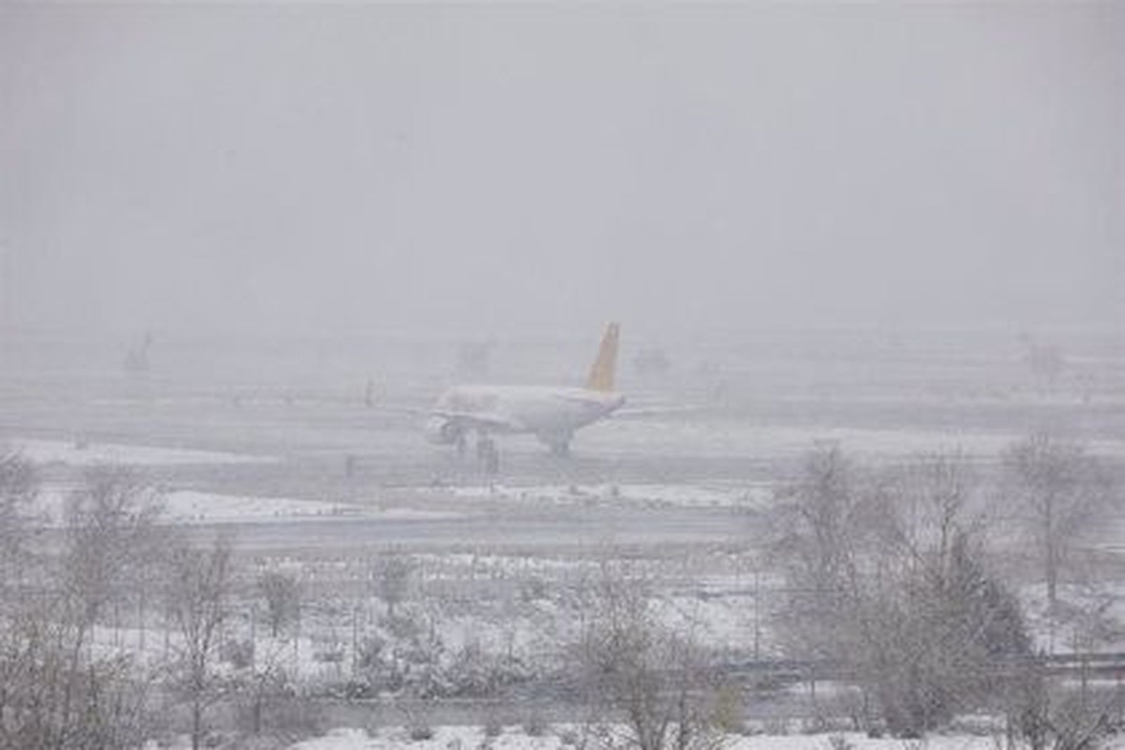 Avión sobre unas pistas nevadas de Barajas