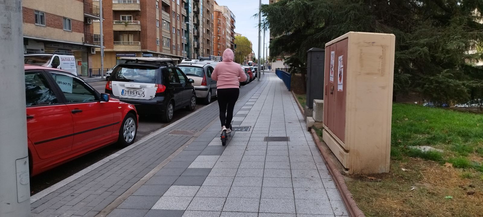 Patinete circulando por la acera. Foto de archivo