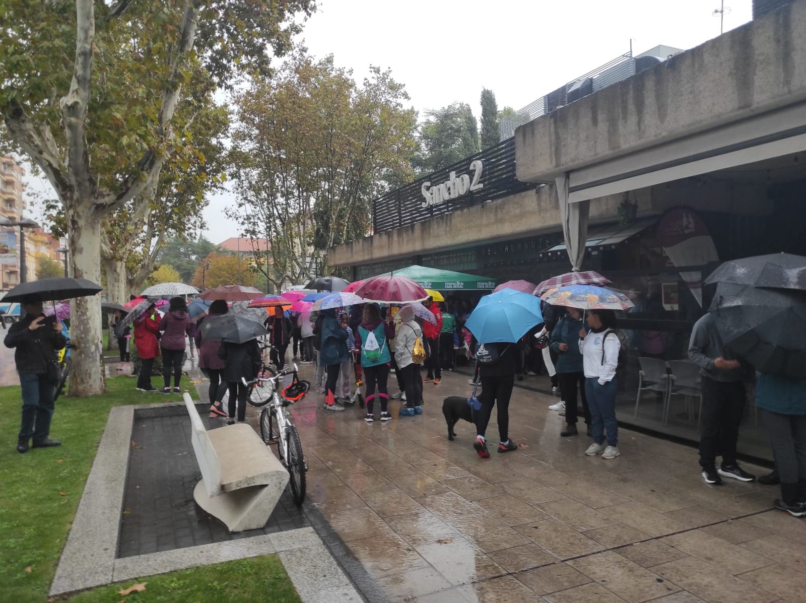 Personas bajo la lluvia en La Marina. Marcha Asprosub