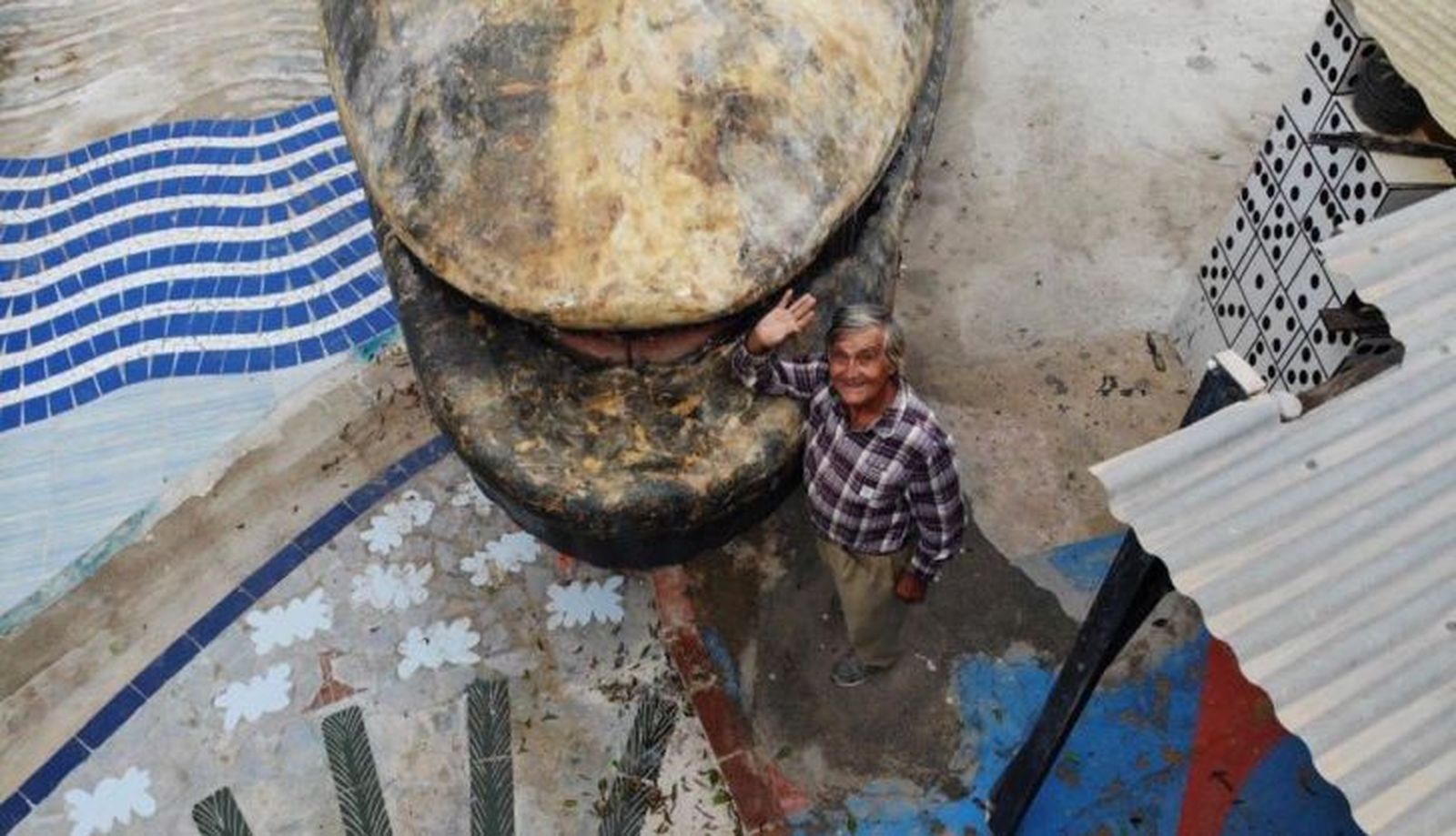 Imagen de Nino posando junto a su obra