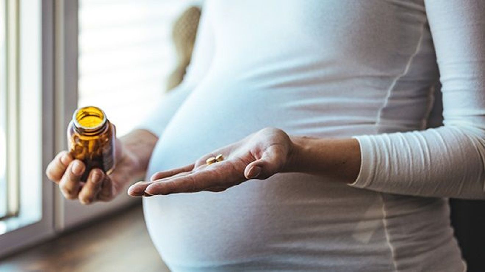 Una mujer embarazada tomando medicamentos